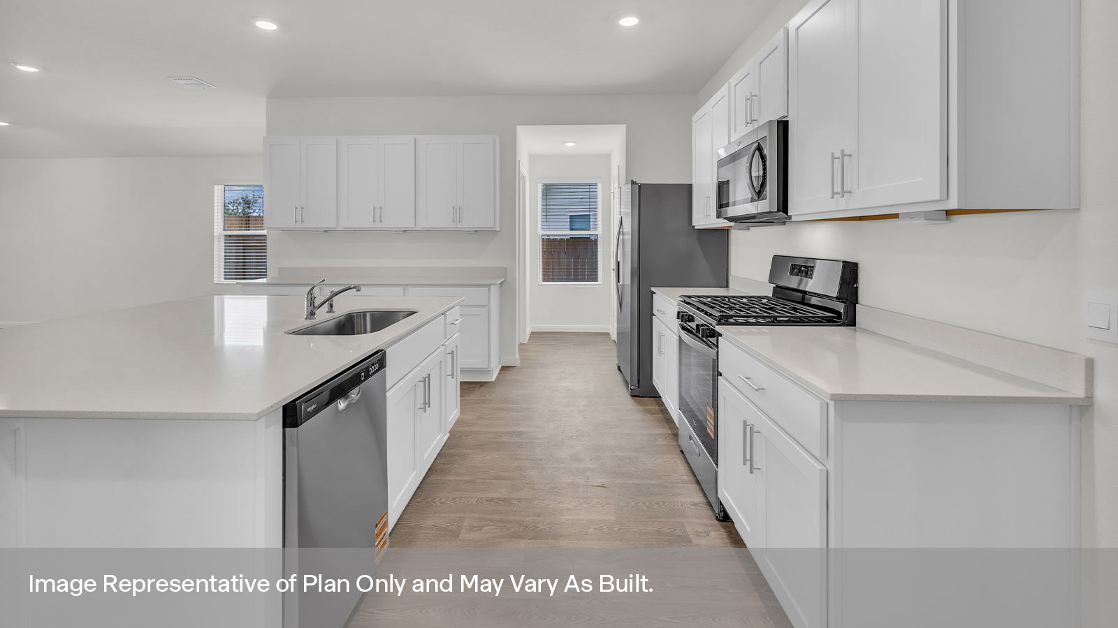 Kitchen with quartz countertops and stainless steel appliances.