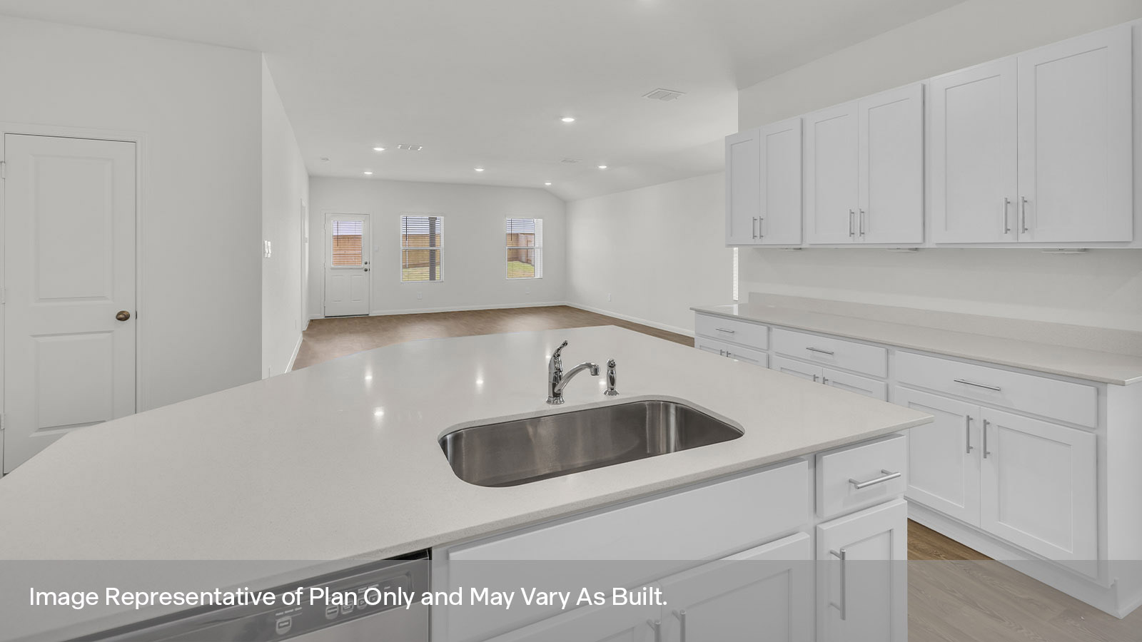 Kitchen island with stainless steel sink overlooking the living room.