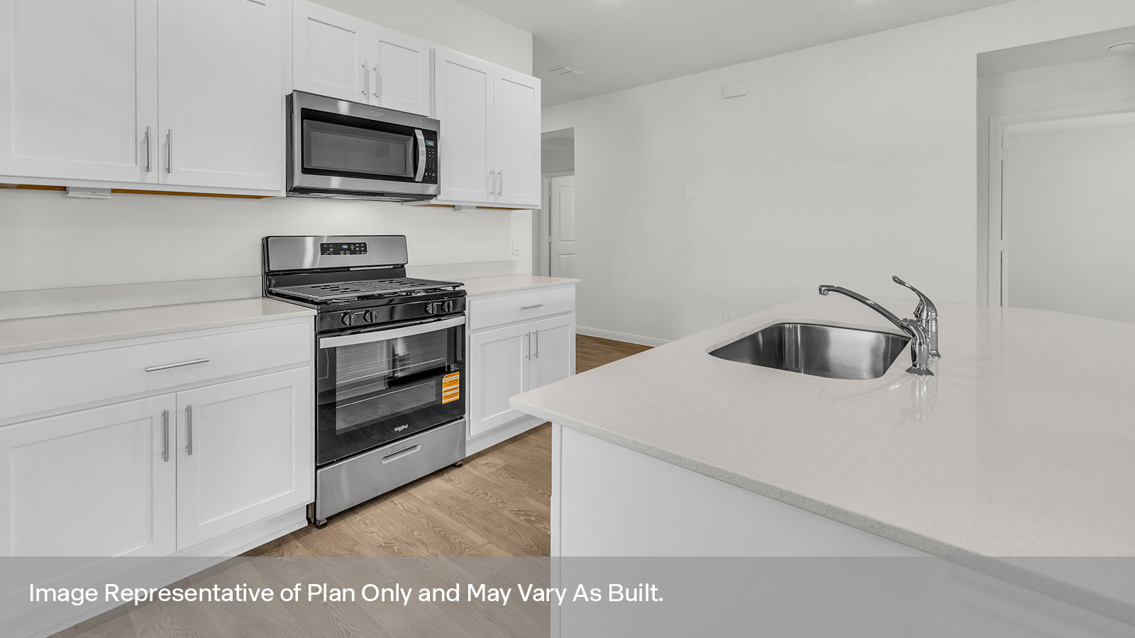 Kitchen with quartz countertops and stainless steel appliances.