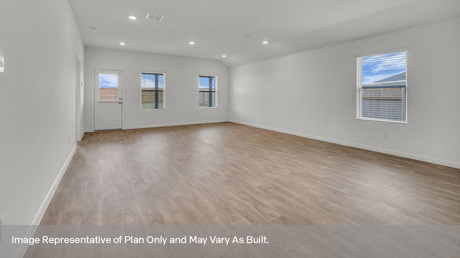 Dining room and living room with vinyl flooring and 3 windows.