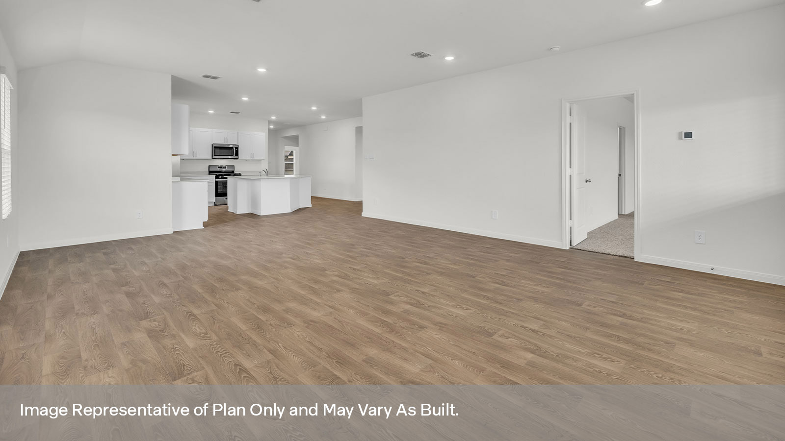 Living room with vinyl flooring, two windows, and a half lite exterior door.