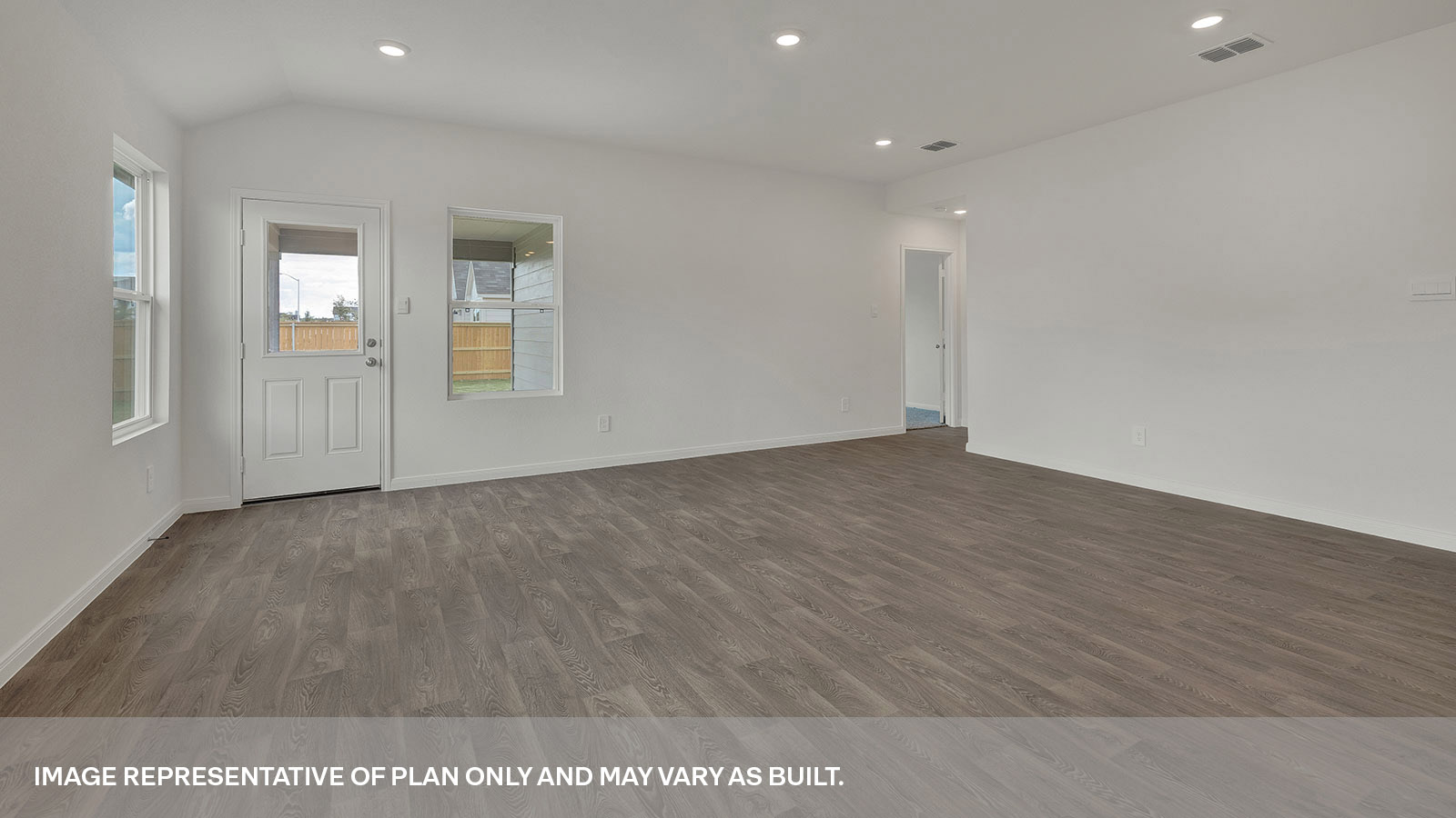 Living room with vinyl flooring, 3 windows, and half lite exterior door.
