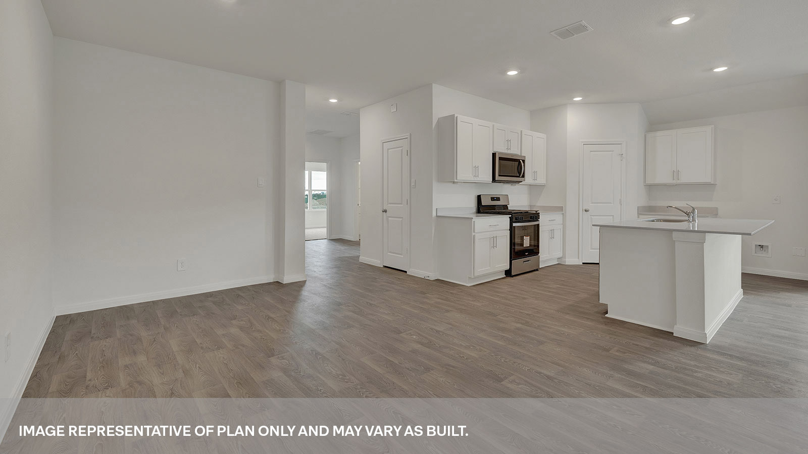 Dining room and kitchen with vinyl flooring and entry hallway.