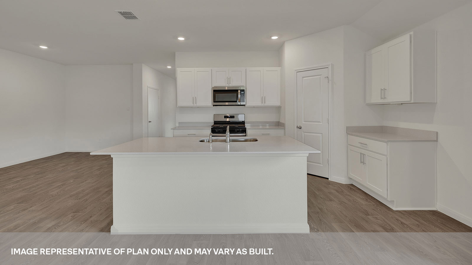 Kitchen with kitchen island and white cabinets.