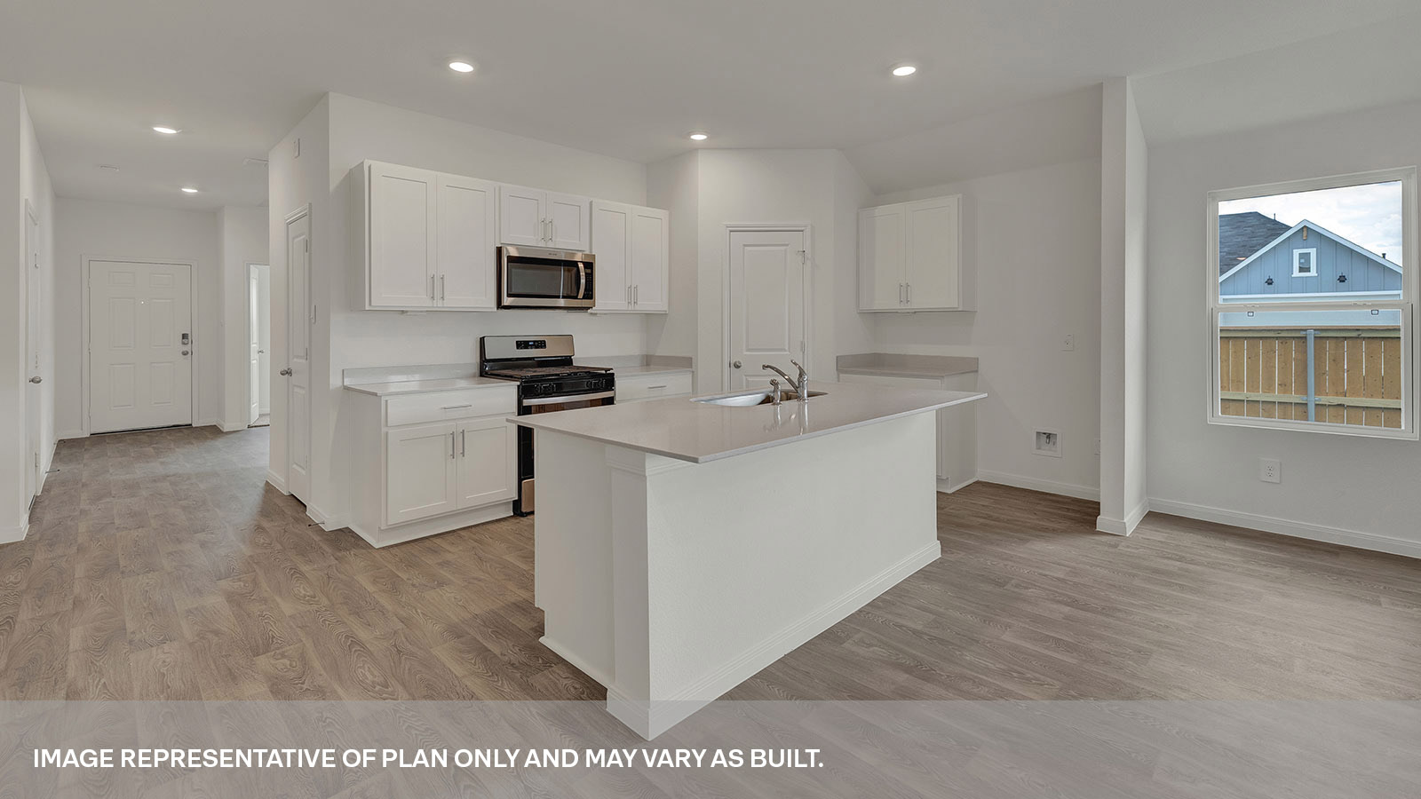 Kitchen with kitchen island and entry hallway.
