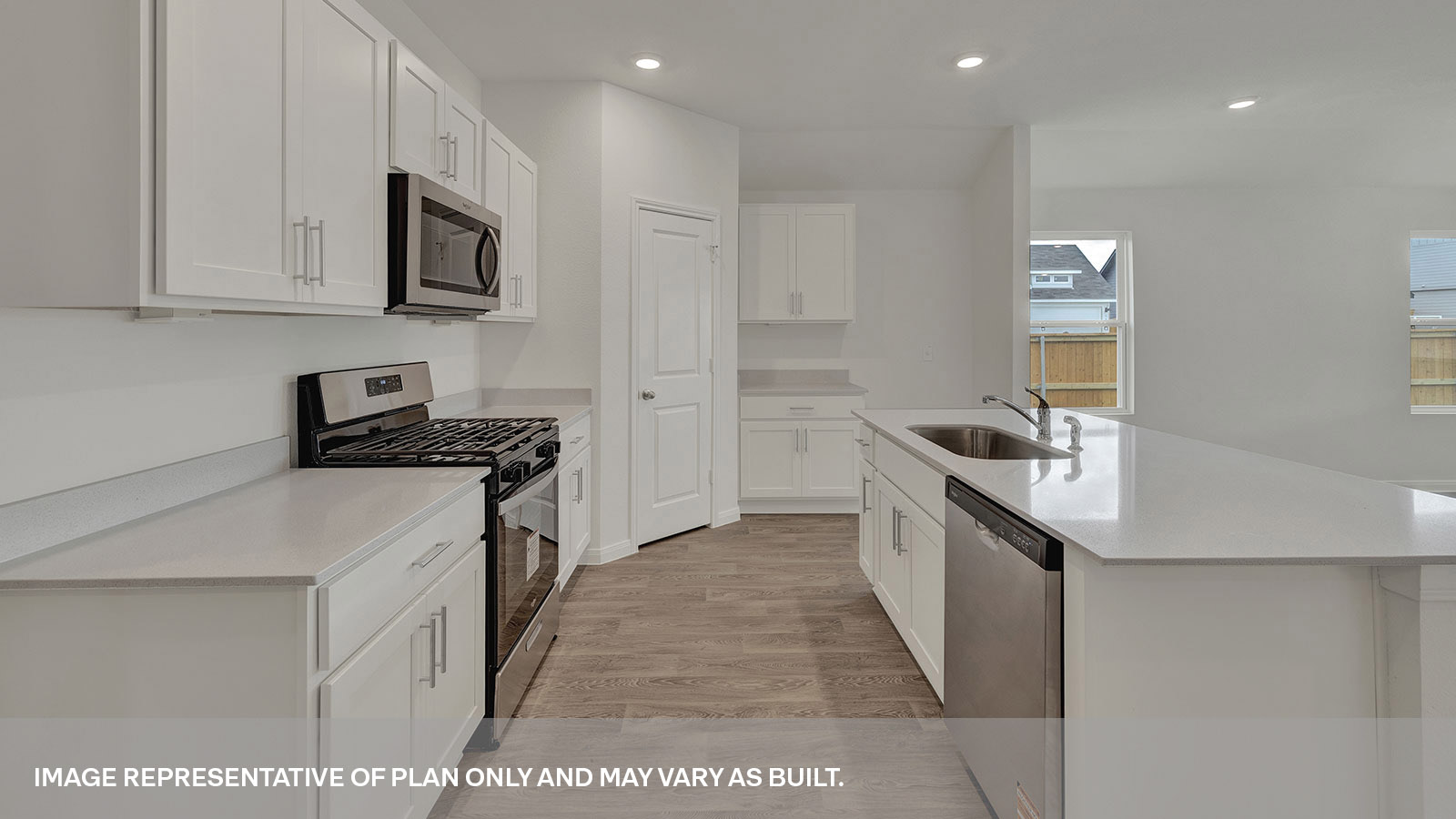 Kitchen with kitchen island and white cabinets.