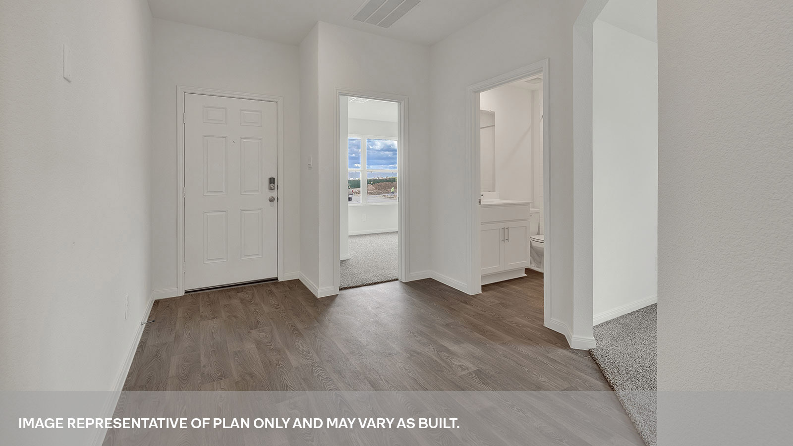 Entry hallway with vinyl flooring and front door.