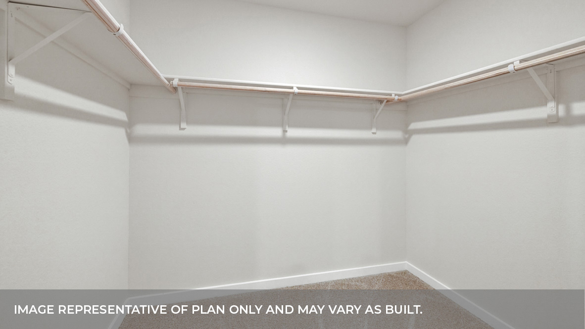 Main bedroom with carpeting and wooden shelving.