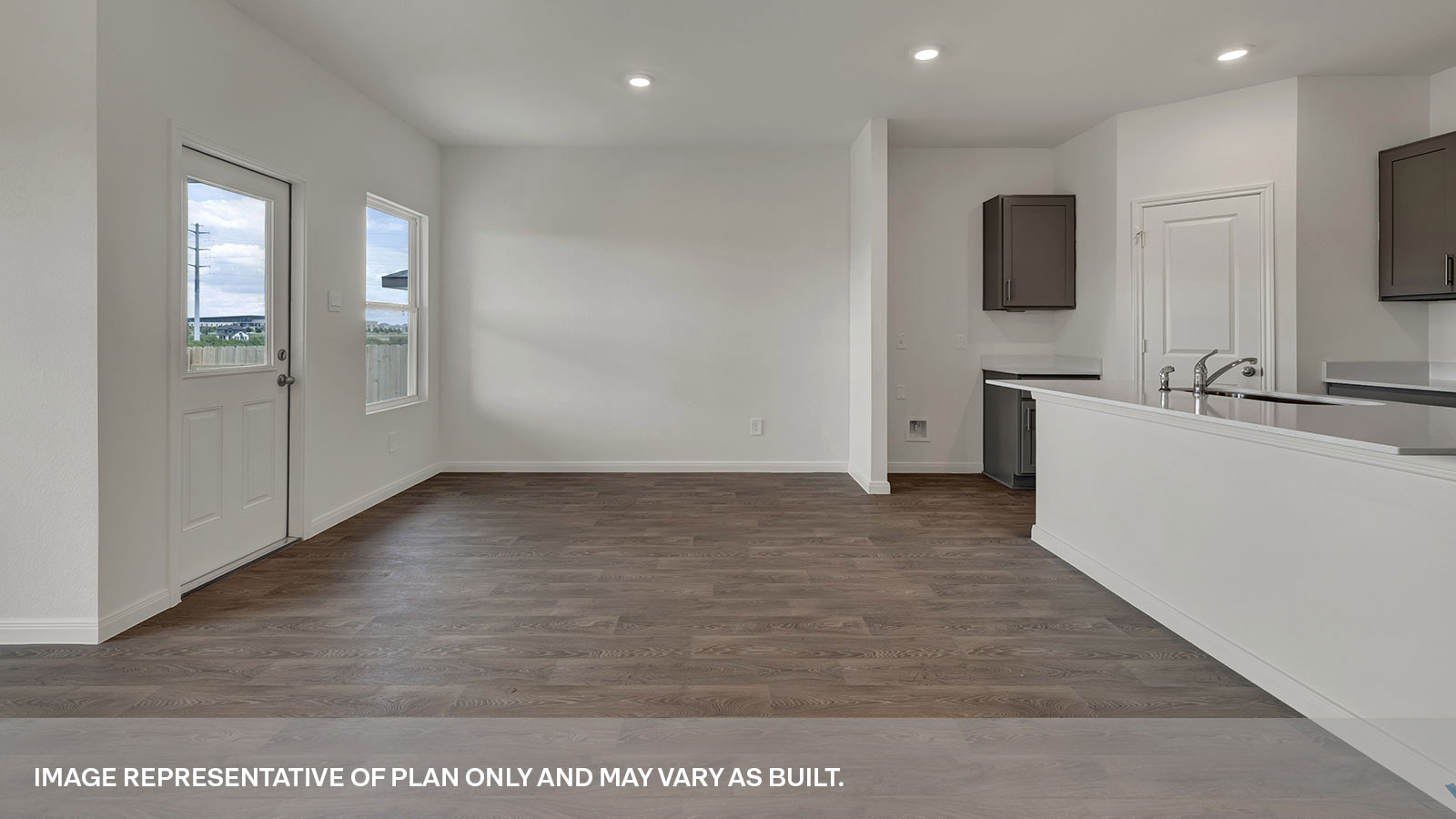 Dining room with vinyl flooring, 2 windows, and a half lite exterior door.