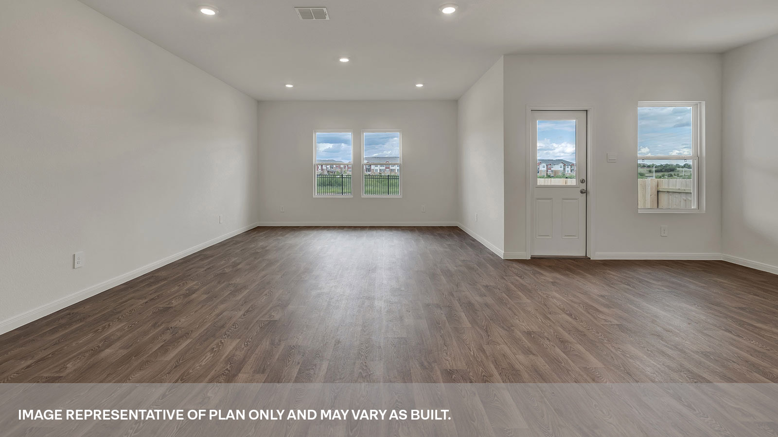 Living room with vinyl flooring and two windows.