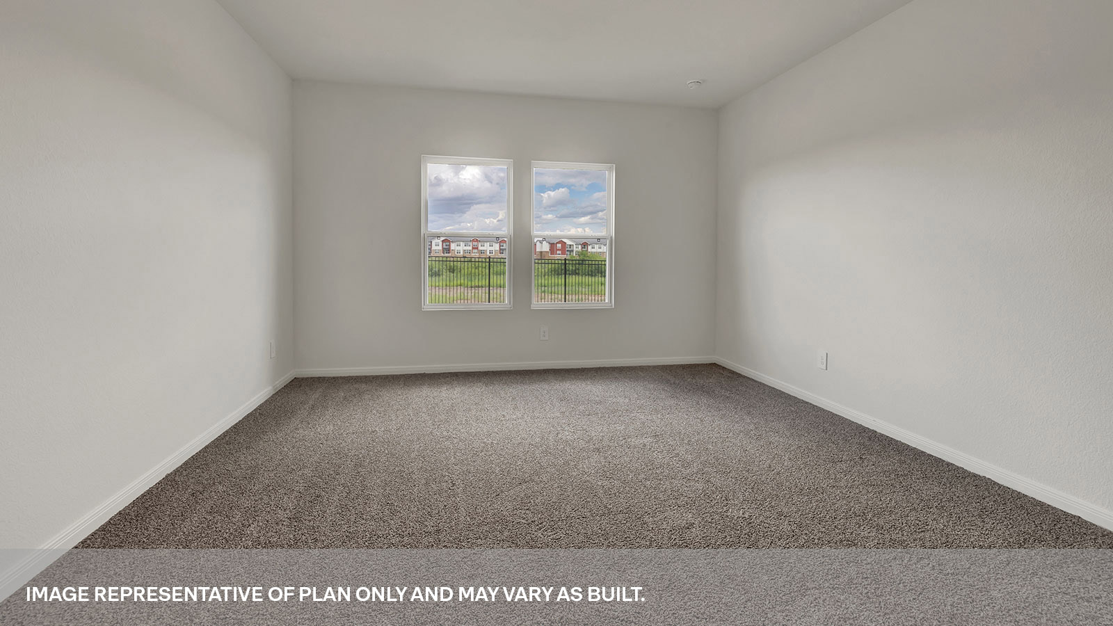 Main bedroom with carpeting and two windows.