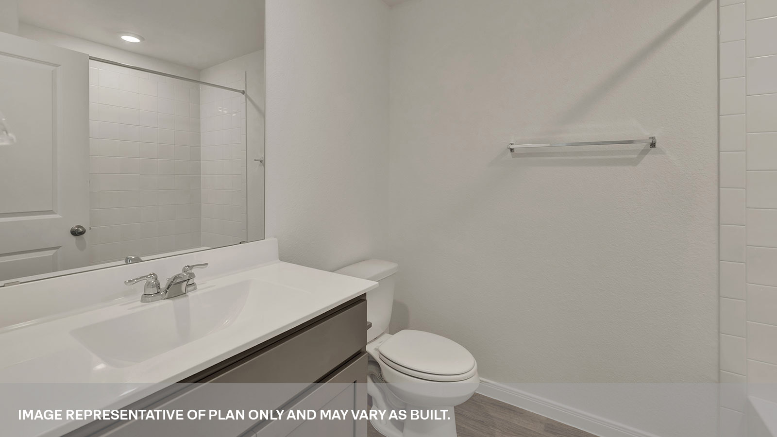 Bathroom with single sink vanity and toilet.