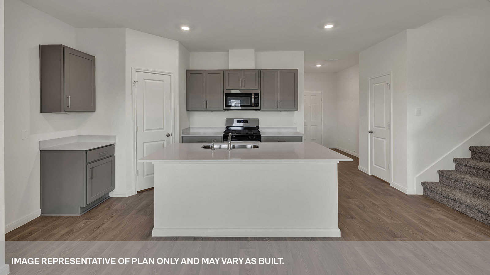 Kitchen with kitchen island and grey cabinets.