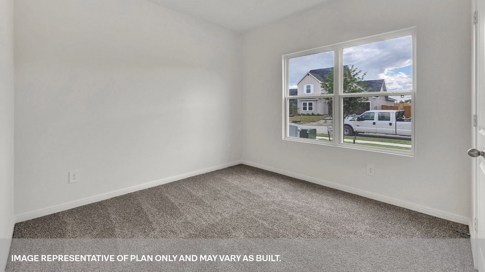 Front bedroom with carpeting and two windows.
