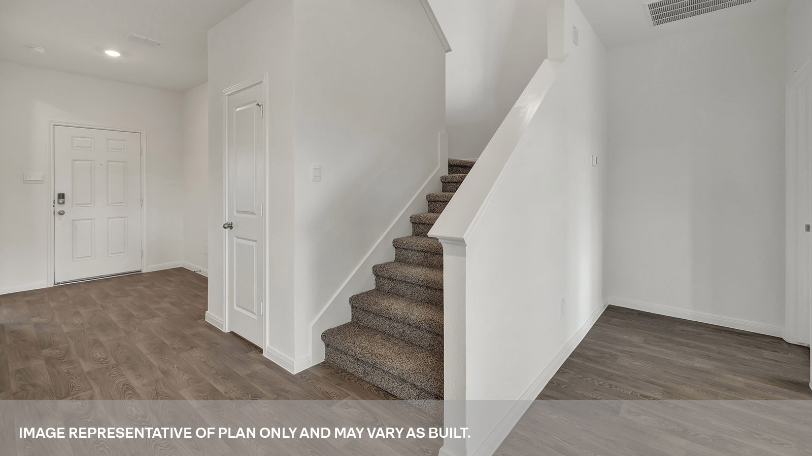Entryway with staircase to the second floor.
