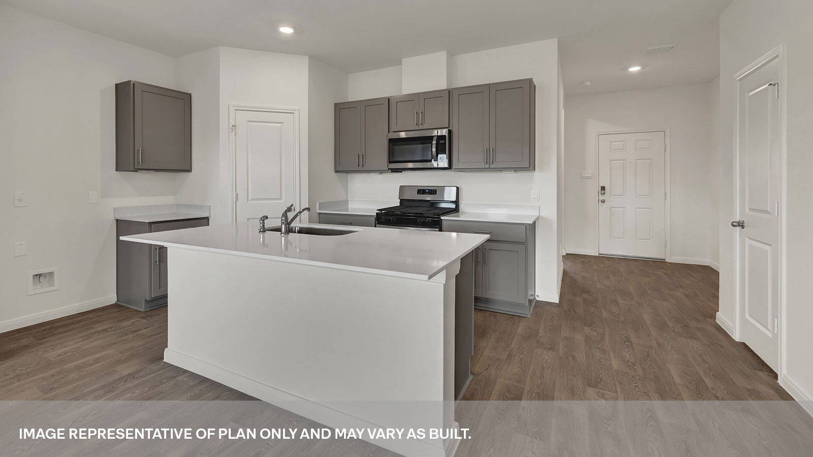 Kitchen and entry hallway with vinyl flooring.