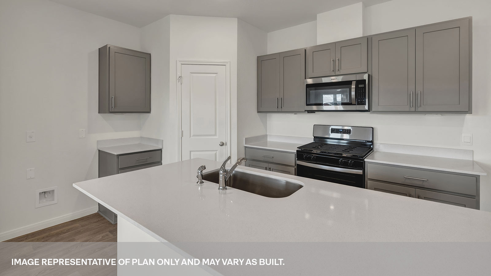 Kitchen with kitchen island and quartz countertops.