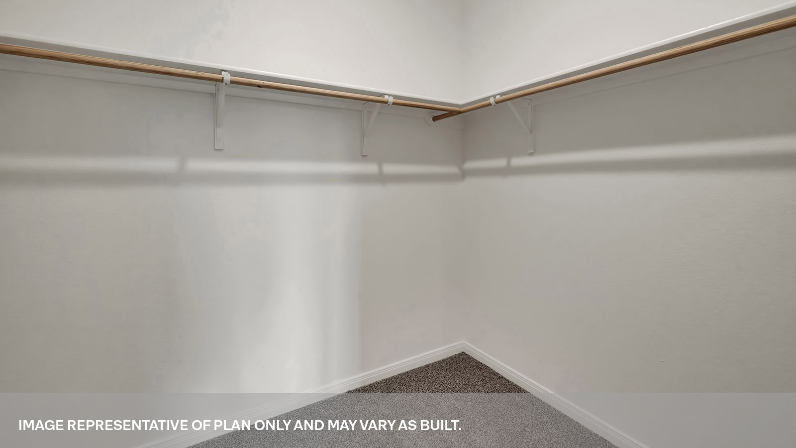 Walk-in closet with wooden shelving and carpeting.