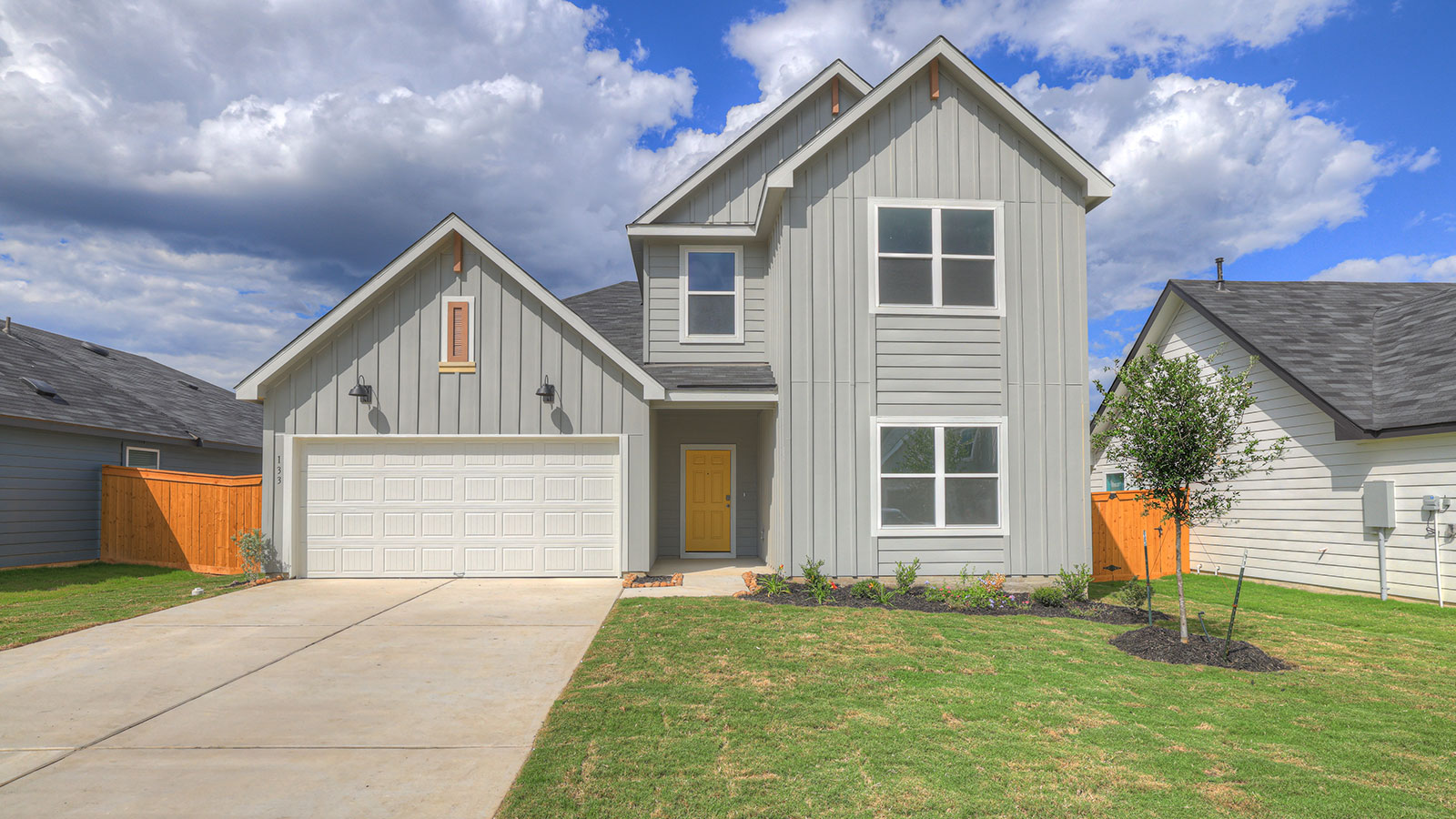 Two-story floorplan with farmhouse exteriors, 4 windows, and a 2 car garage.