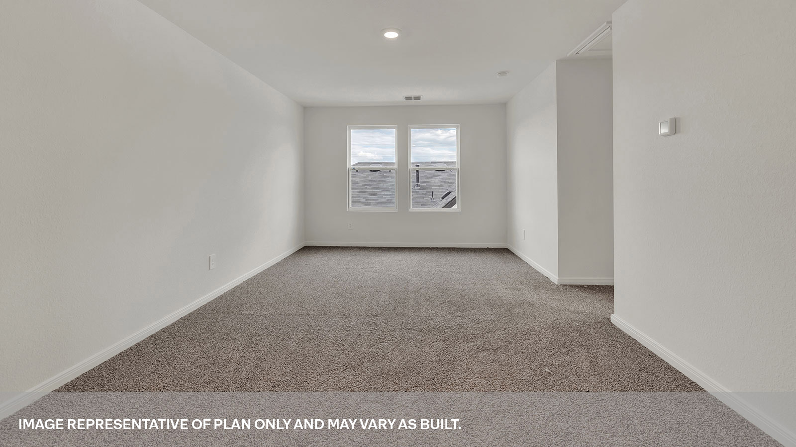 Loft with carpeting and two windows.