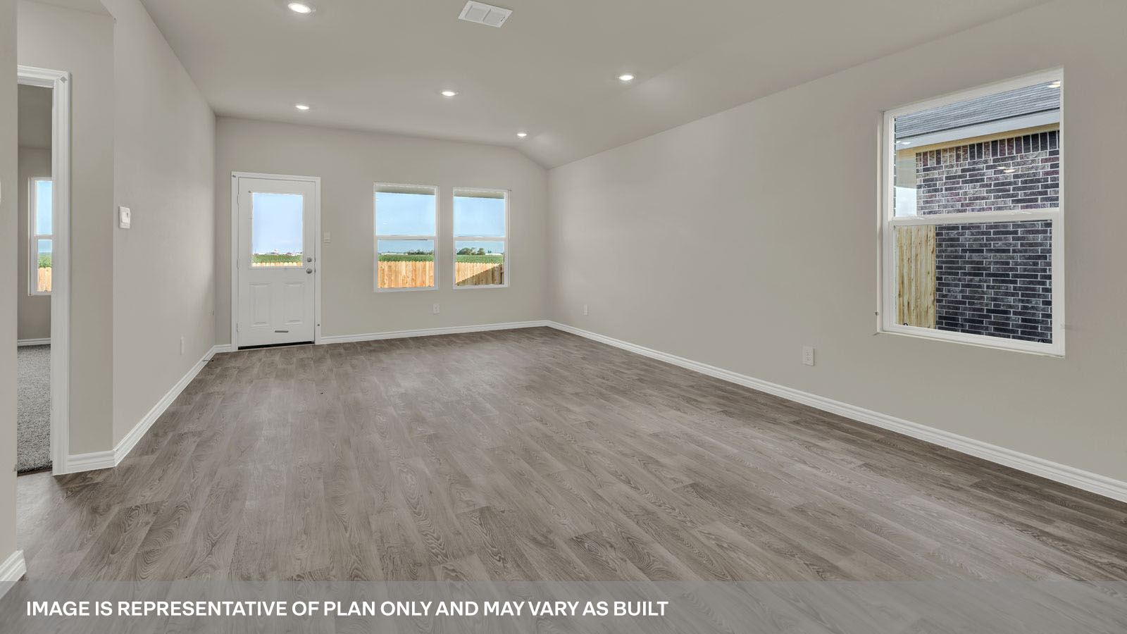 Dining room and living room with vinyl flooring, windows, and a half lite exterior door.