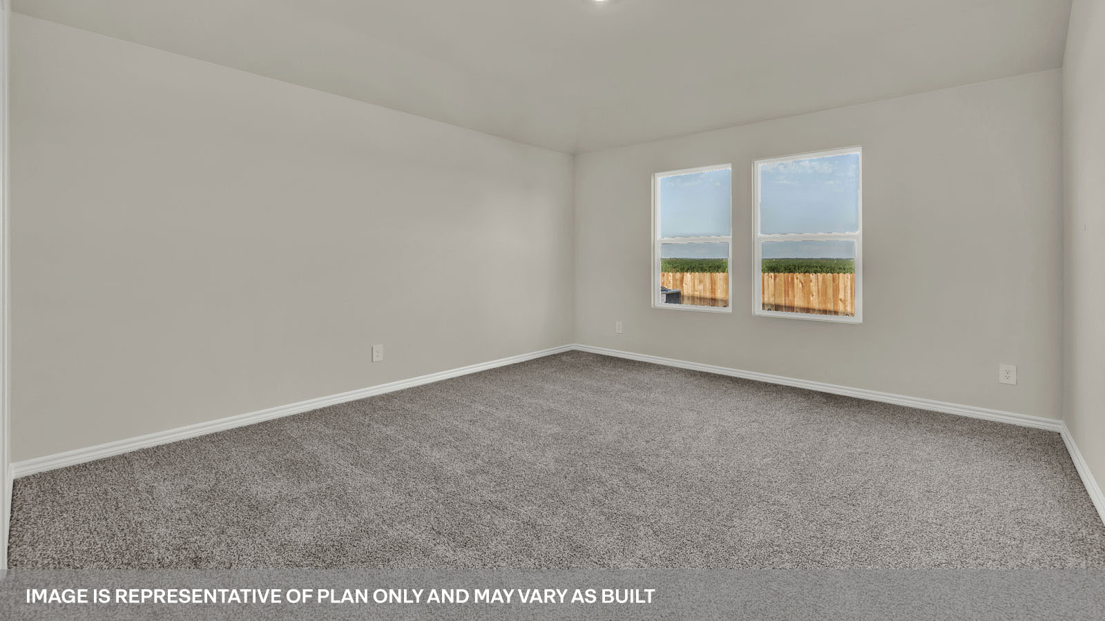Main bedroom with carpeting and two windows.