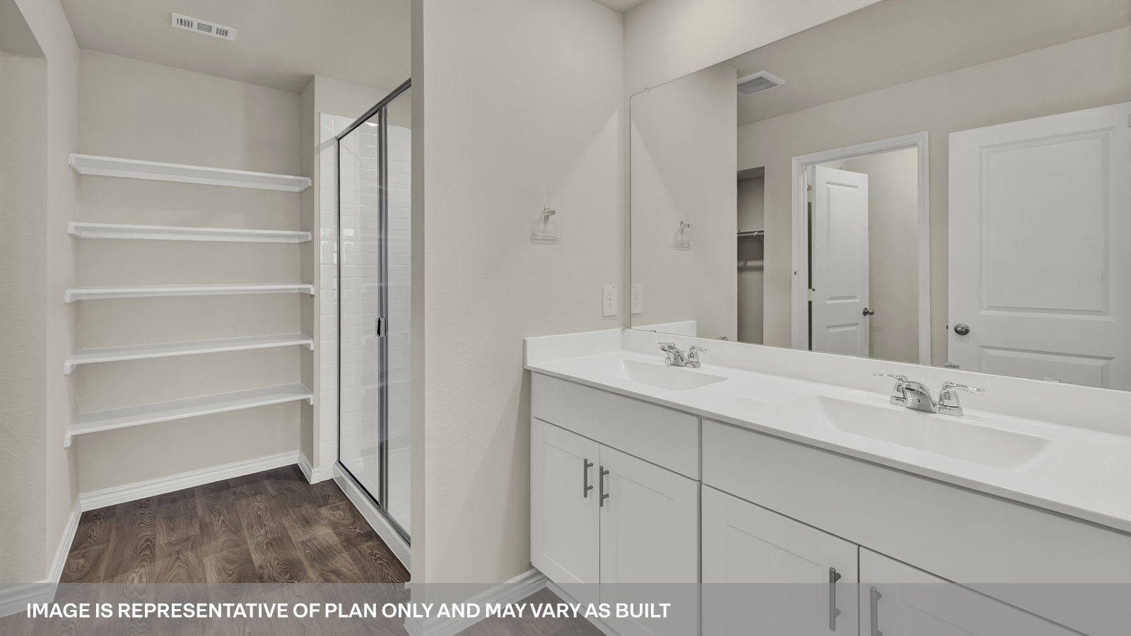 Main bathroom with double sink vanity, walk-in shower and closet.