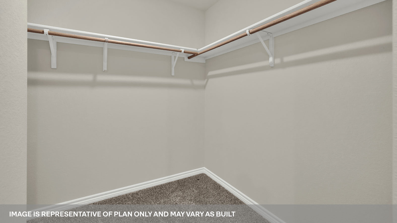 Main bedroom closet with carpeting and wooden shelving.