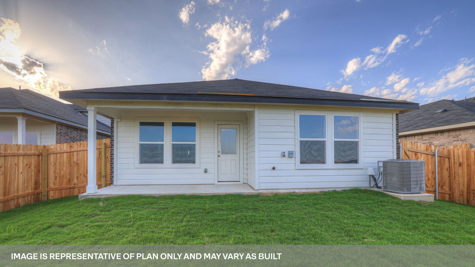 Covered patio overlooking a fully sodded backyard and privacy fence.