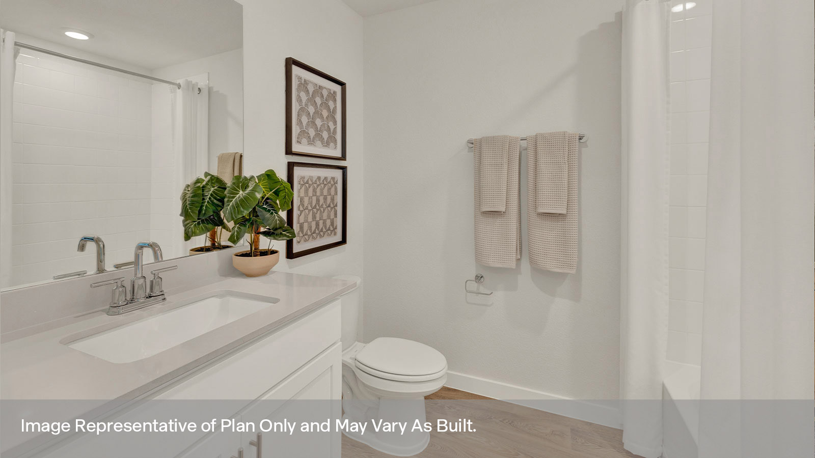 Hall bathroom with vanity, toilet, and, tub tile surround.