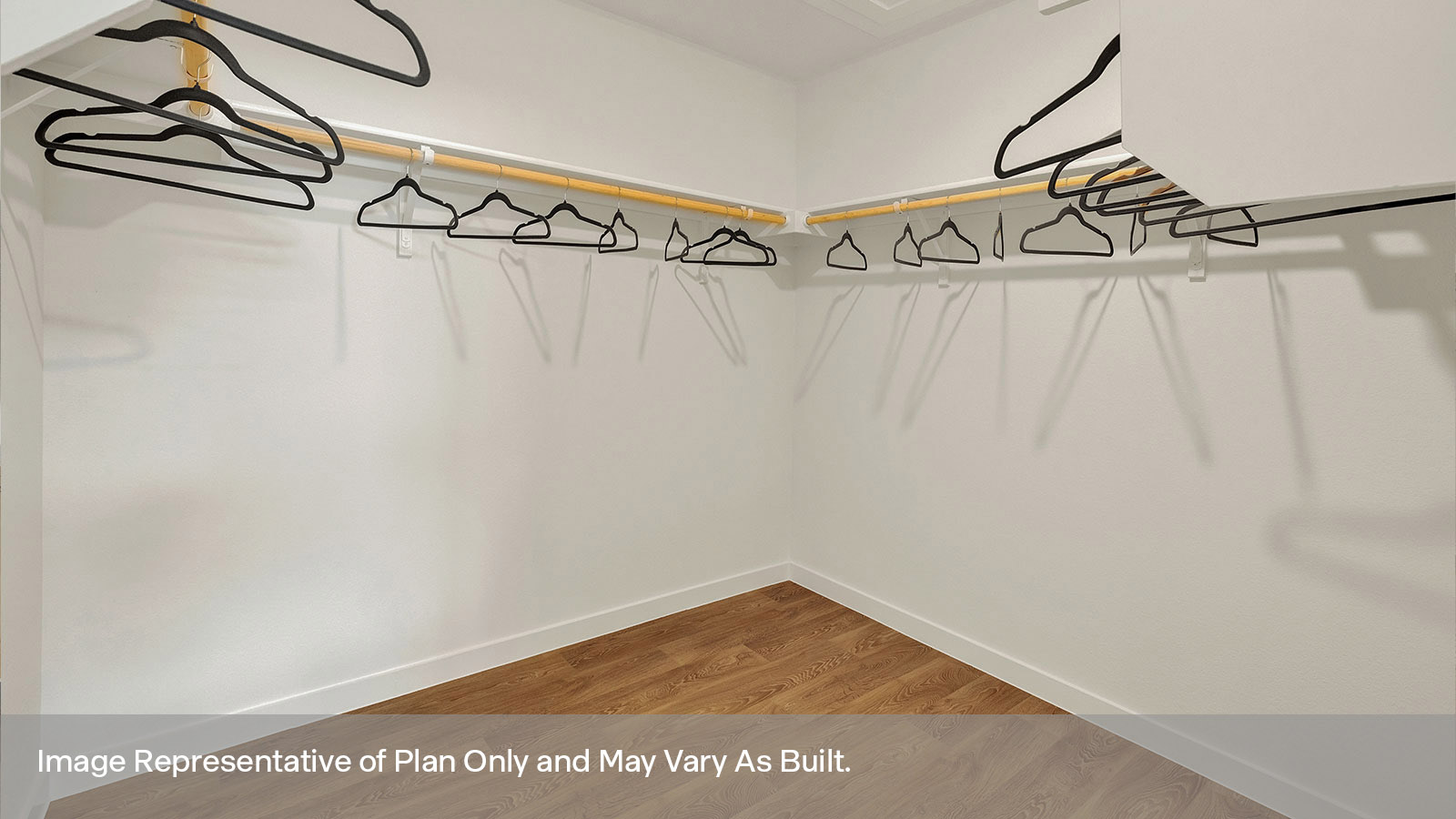 Main bedroom closet with carpeting and wooden shelving.
