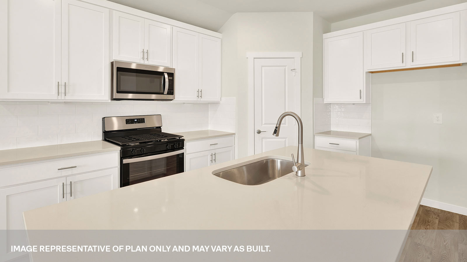Kitchen with kitchen island, white cabinets, and quartz countertops.