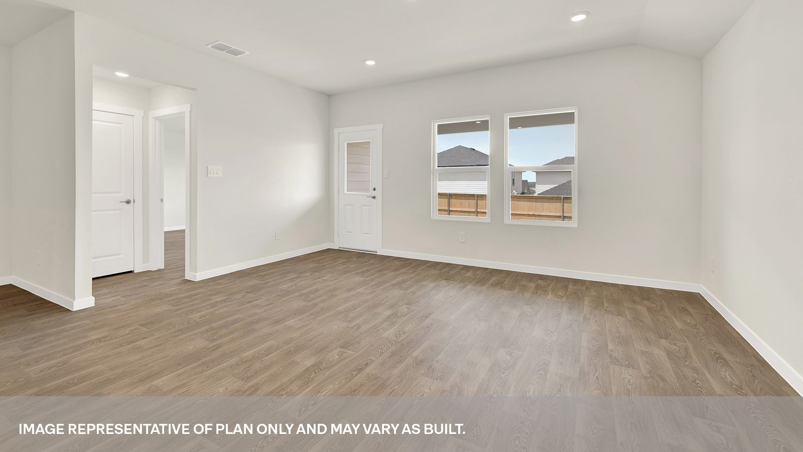 Living room with vinyl flooring, two windows, and a half lite exterior door.