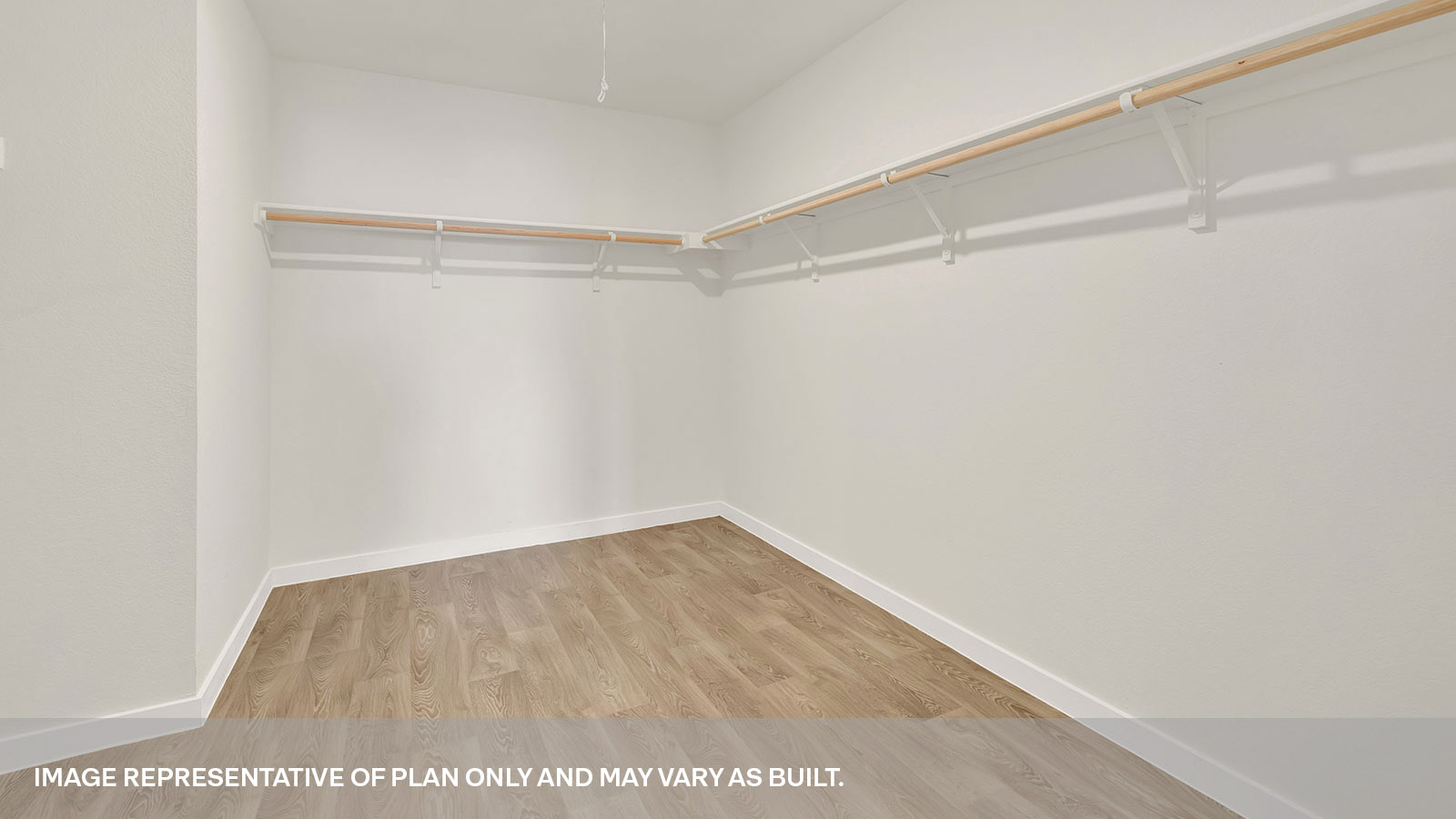 Main bedroom closet with carpeting and wooden shelving.