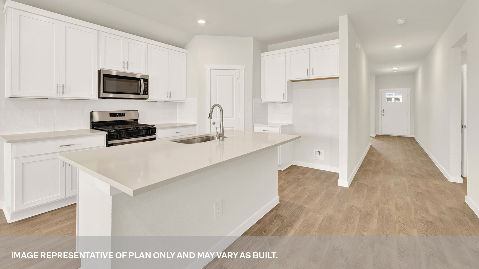 Entry hallway leading to the kitchen with kitchen island.