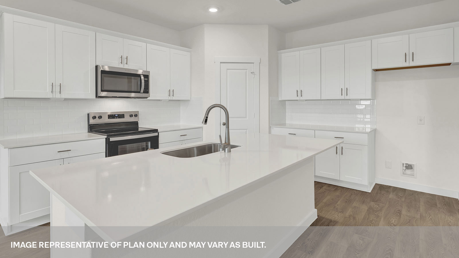 Kitchen with kitchen island and white cabinets.