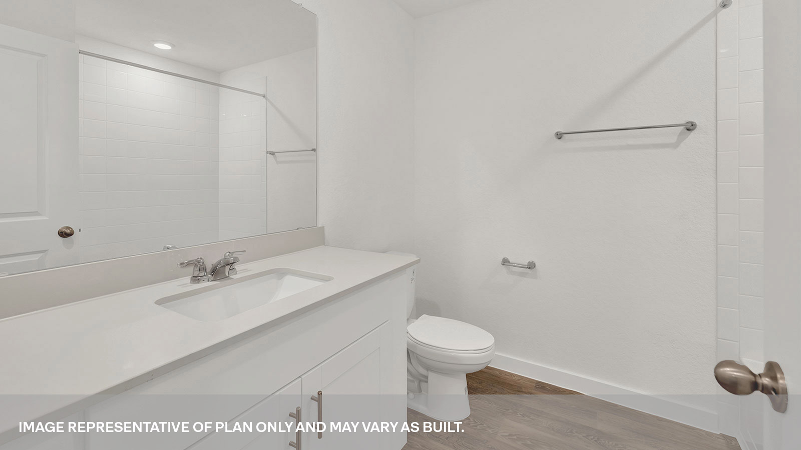 Hall bathroom with vanity, toilet, and tub with tile surround.