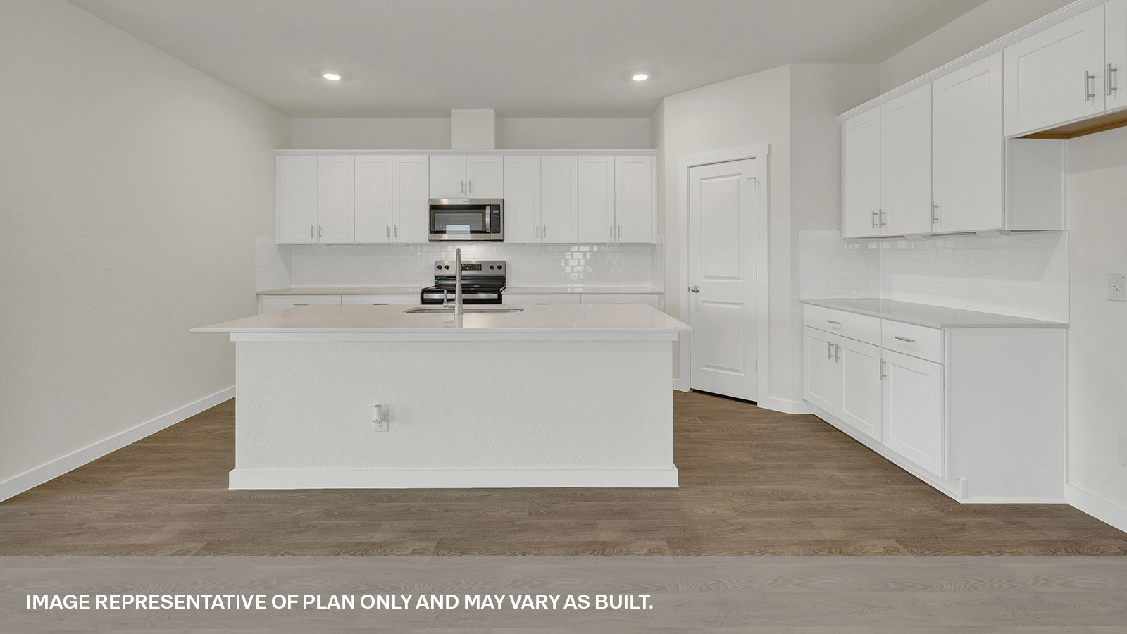 Kitchen with kitchen island and white cabinets.