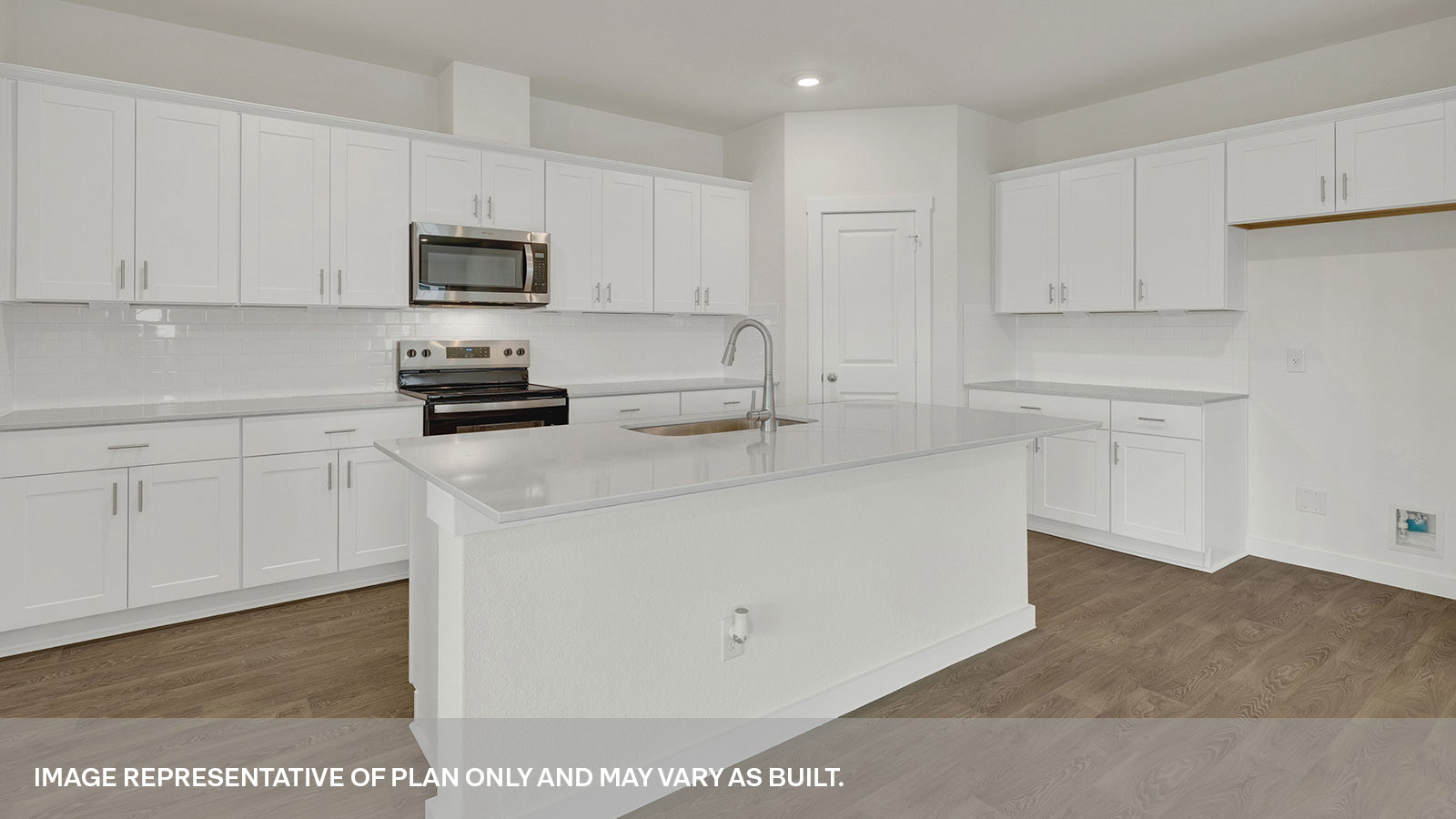 Kitchen with kitchen island and white cabinets.
