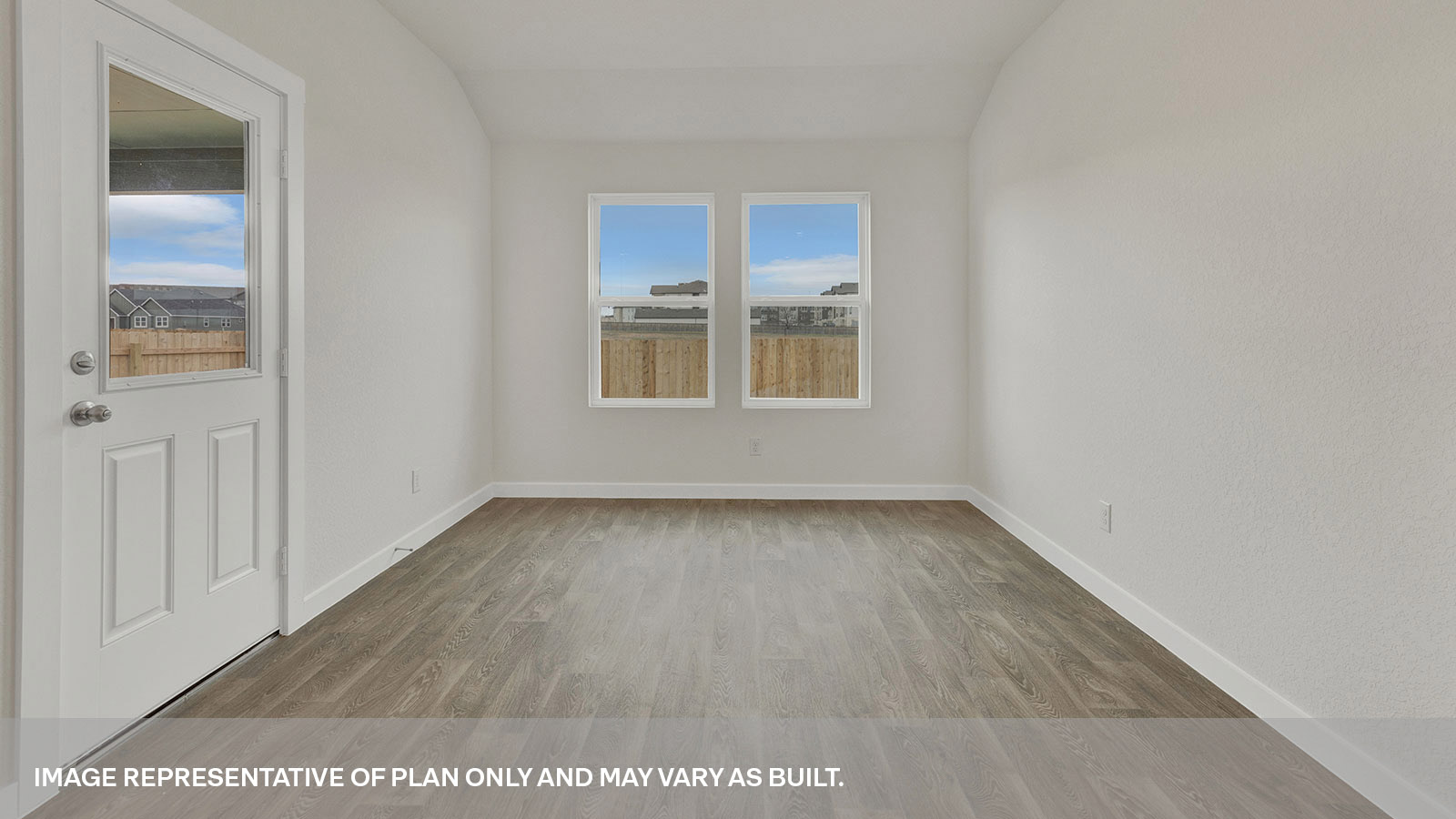 Dining room with vinyl flooring, 2 windows, and a half lite exterior door.