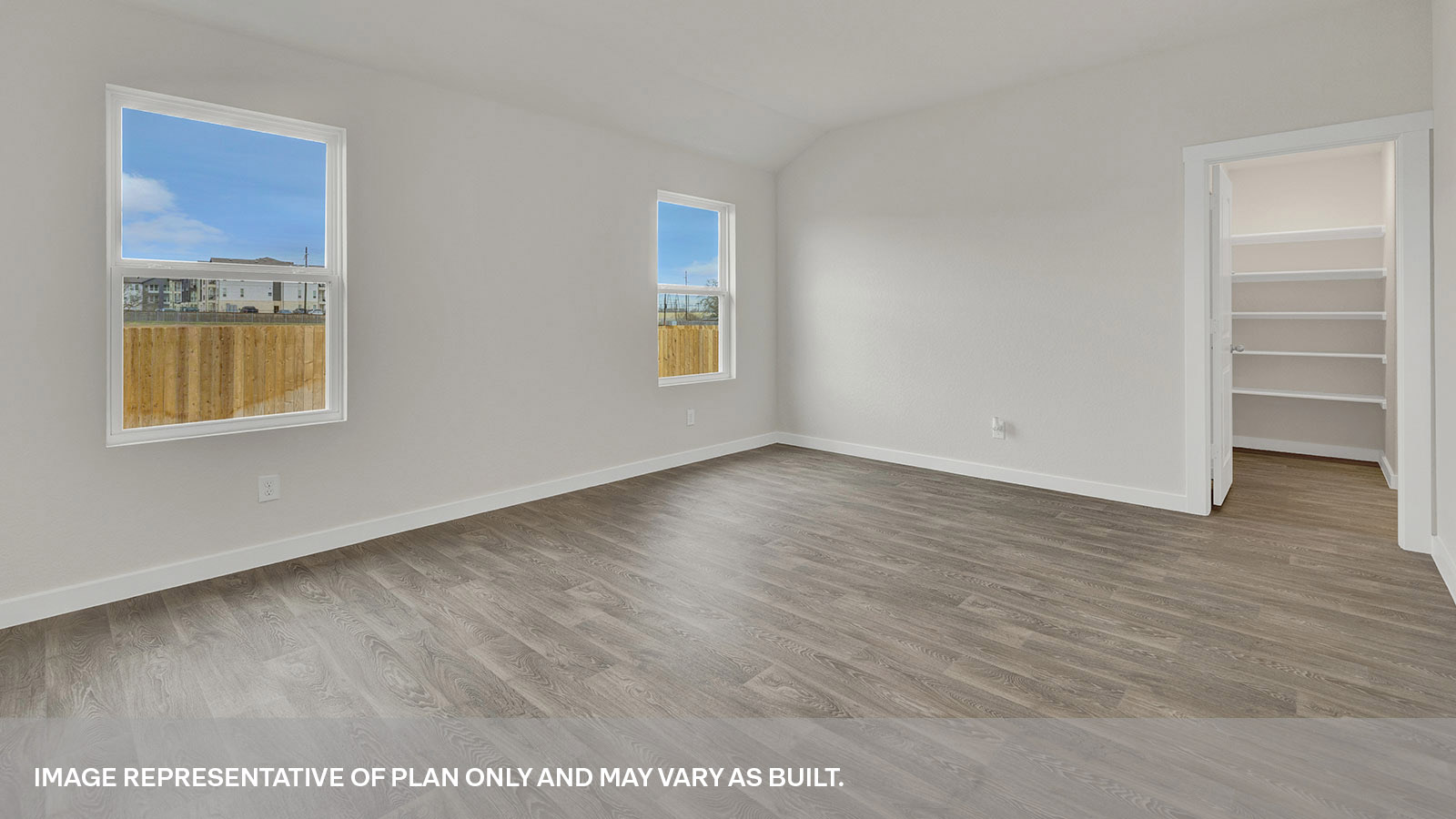 Main bedroom with vinyl flooring and two windows.