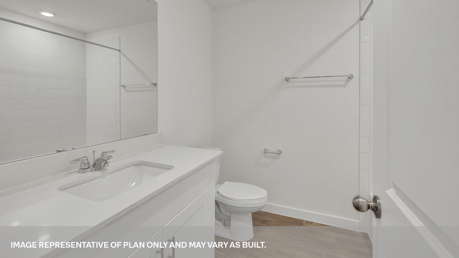 Hall bathroom with vanity, toilet, and tub.