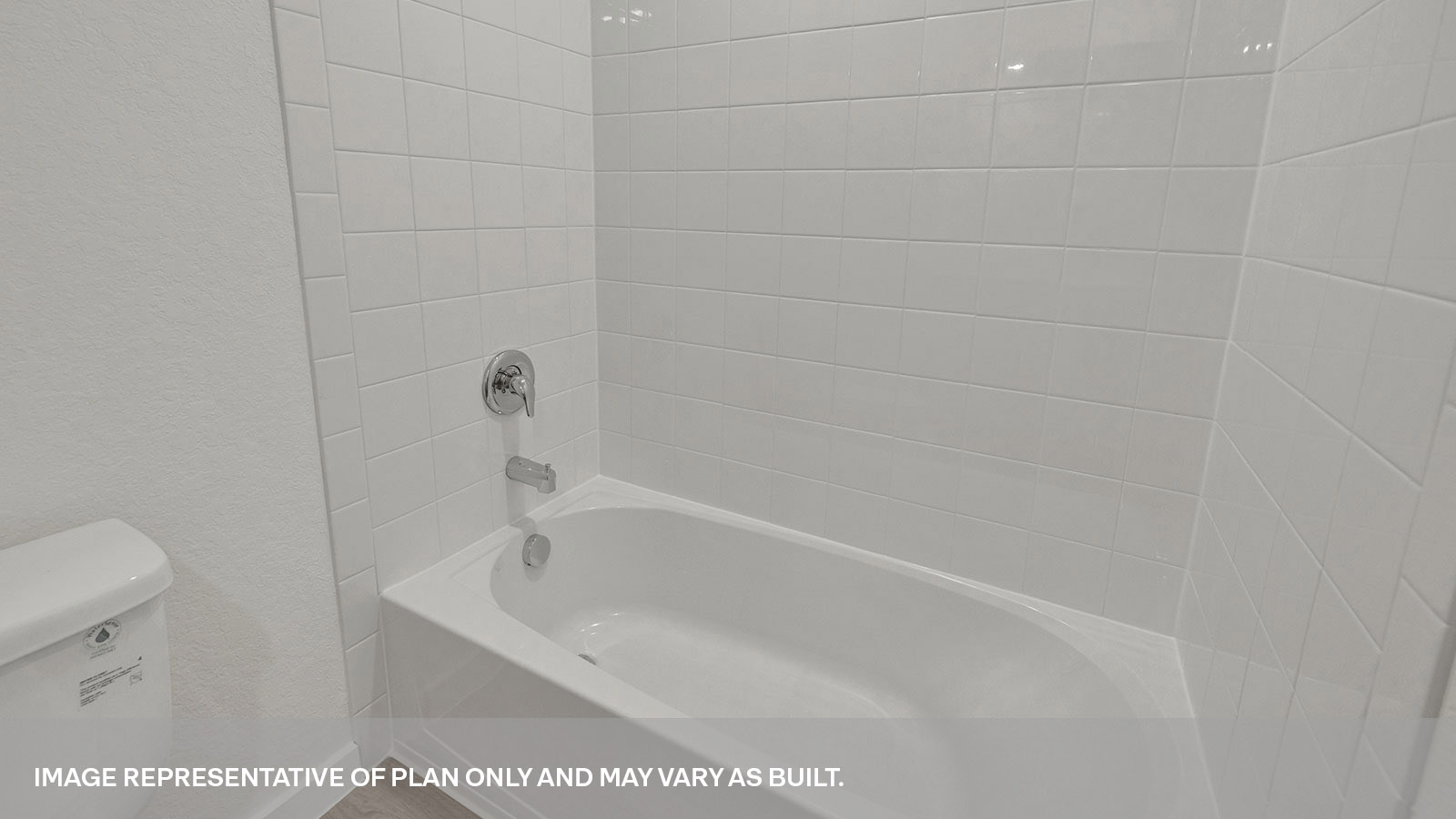 Hall bathroom tub with tile surround.