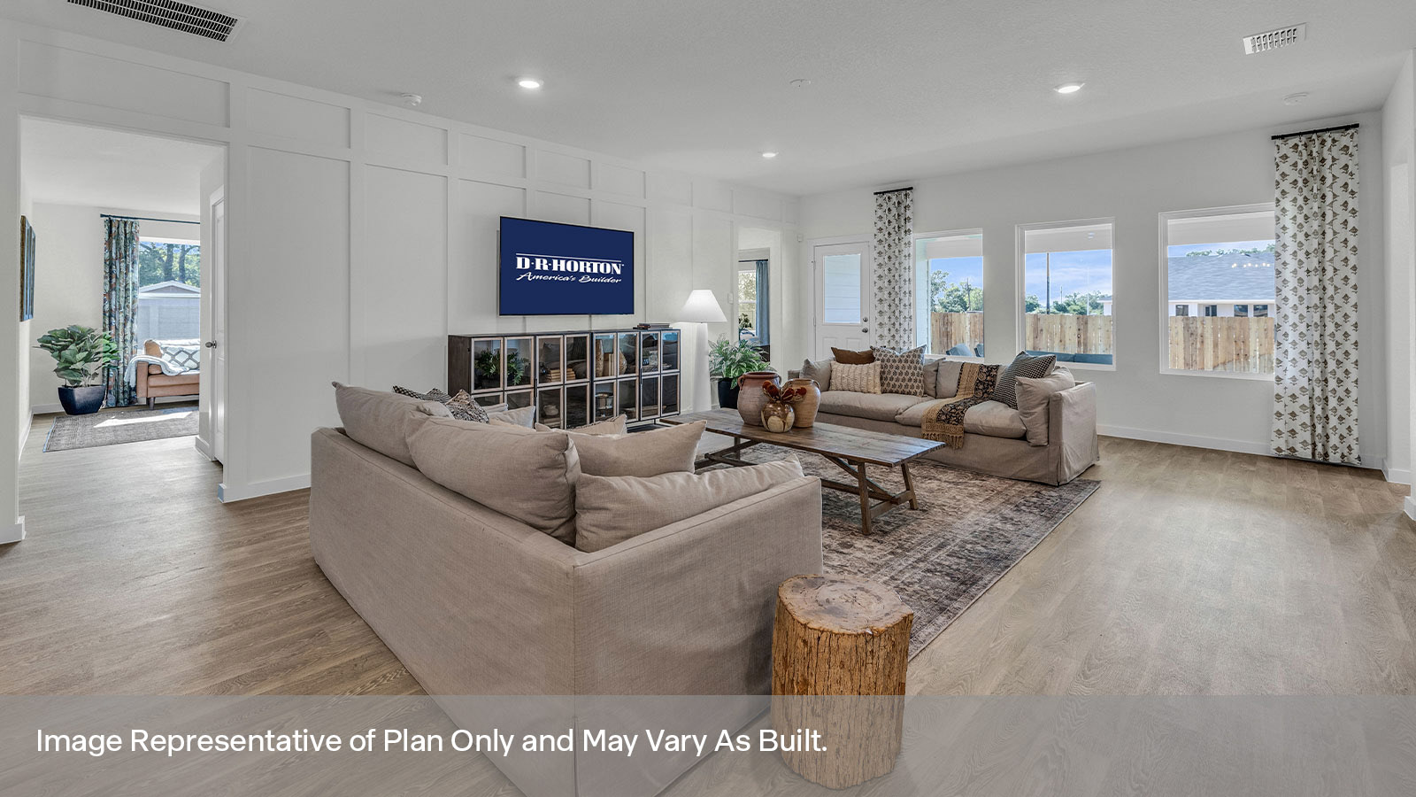 Living room with vinyl flooring, 3 windows, and a half lite exterior door.