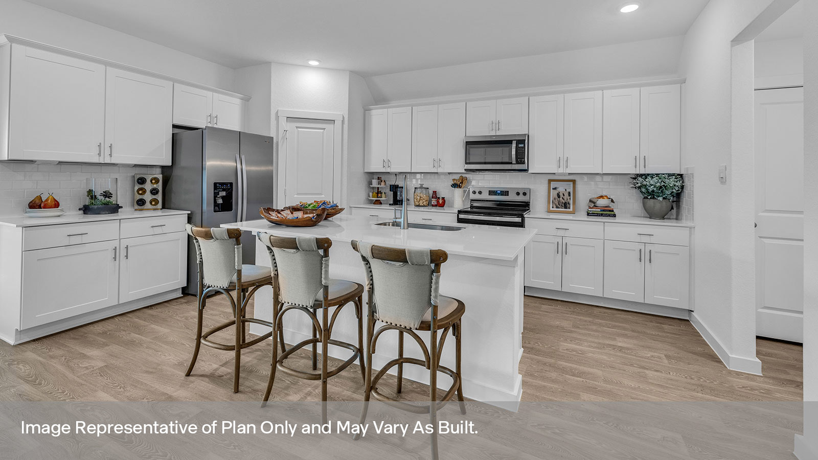 Kitchen with kitchen island and white cabinets.