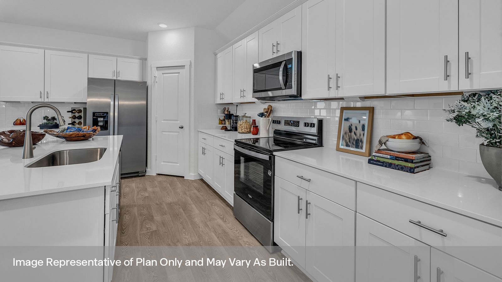 Kitchen with white cabinets and quartz countertops.