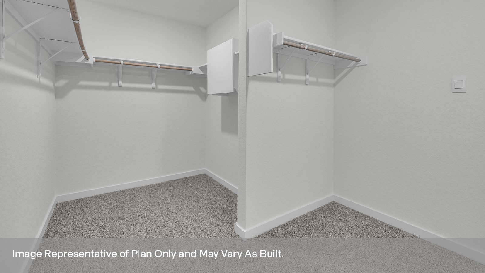 Main bedroom closet with carpeting and wooden shelving.