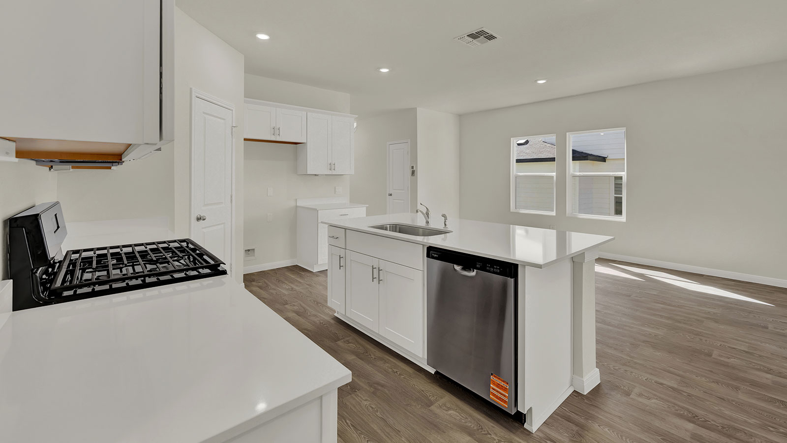 Kitchen island view looking toward the dining area emphasizing serving flow and open design.