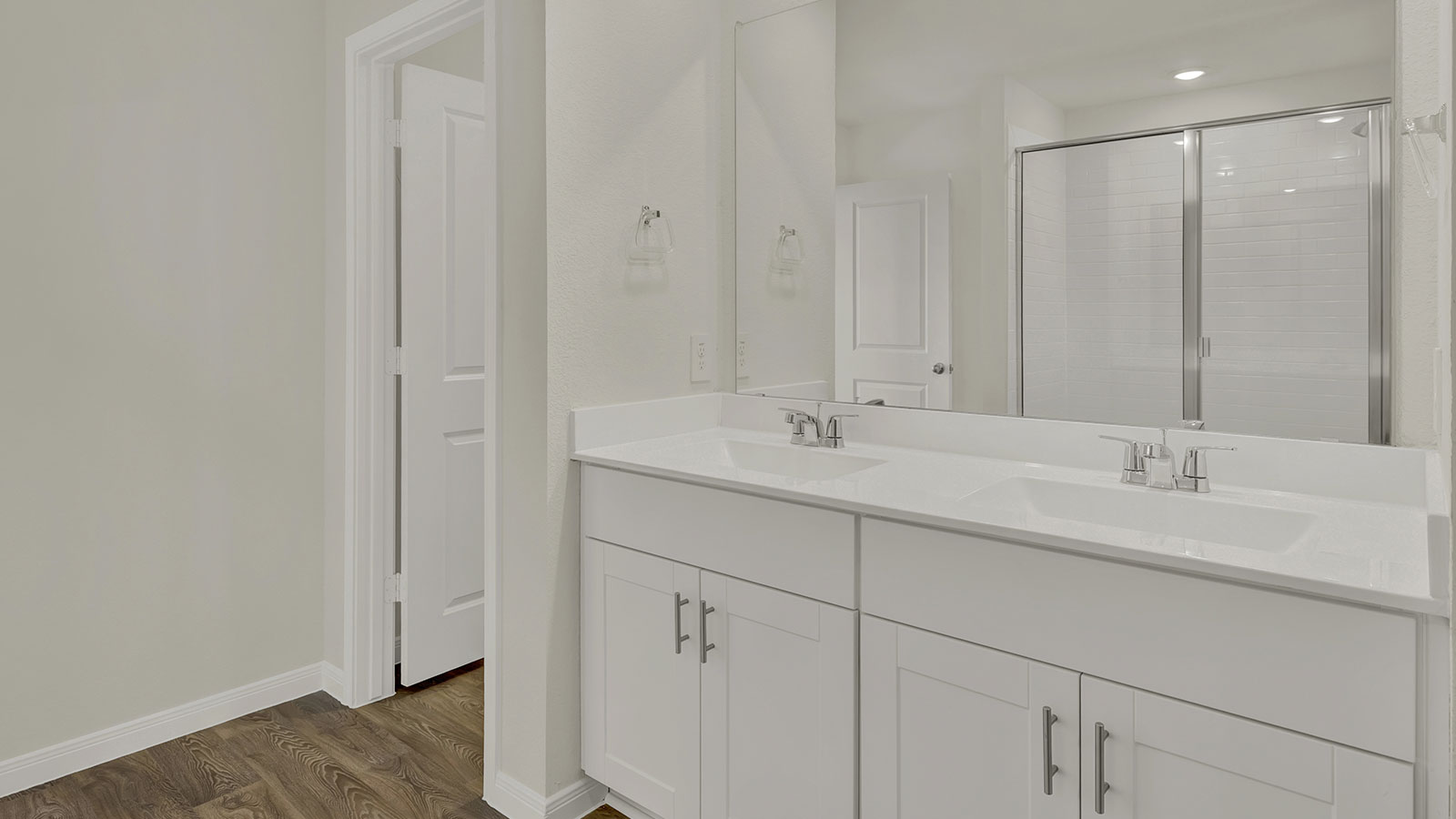 New home stylish ensuite dual vanity design with a tub, step-in shower, cabinets, full-length vanity, near walk-in closet