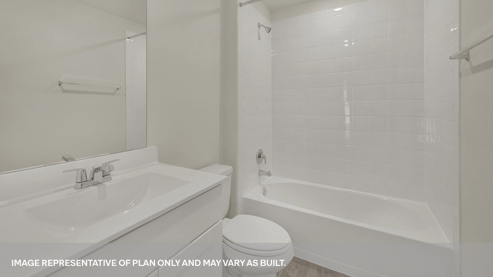 Hall bathroom with vanity, toilet, and tub with tile surround.